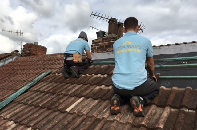 the Beta Roofs Team on a roof